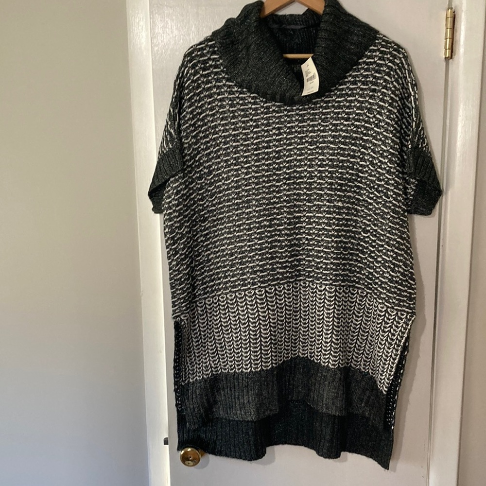 Woman’s Plus black and white short sleeve Lane Bryant sweater with cowl neck.